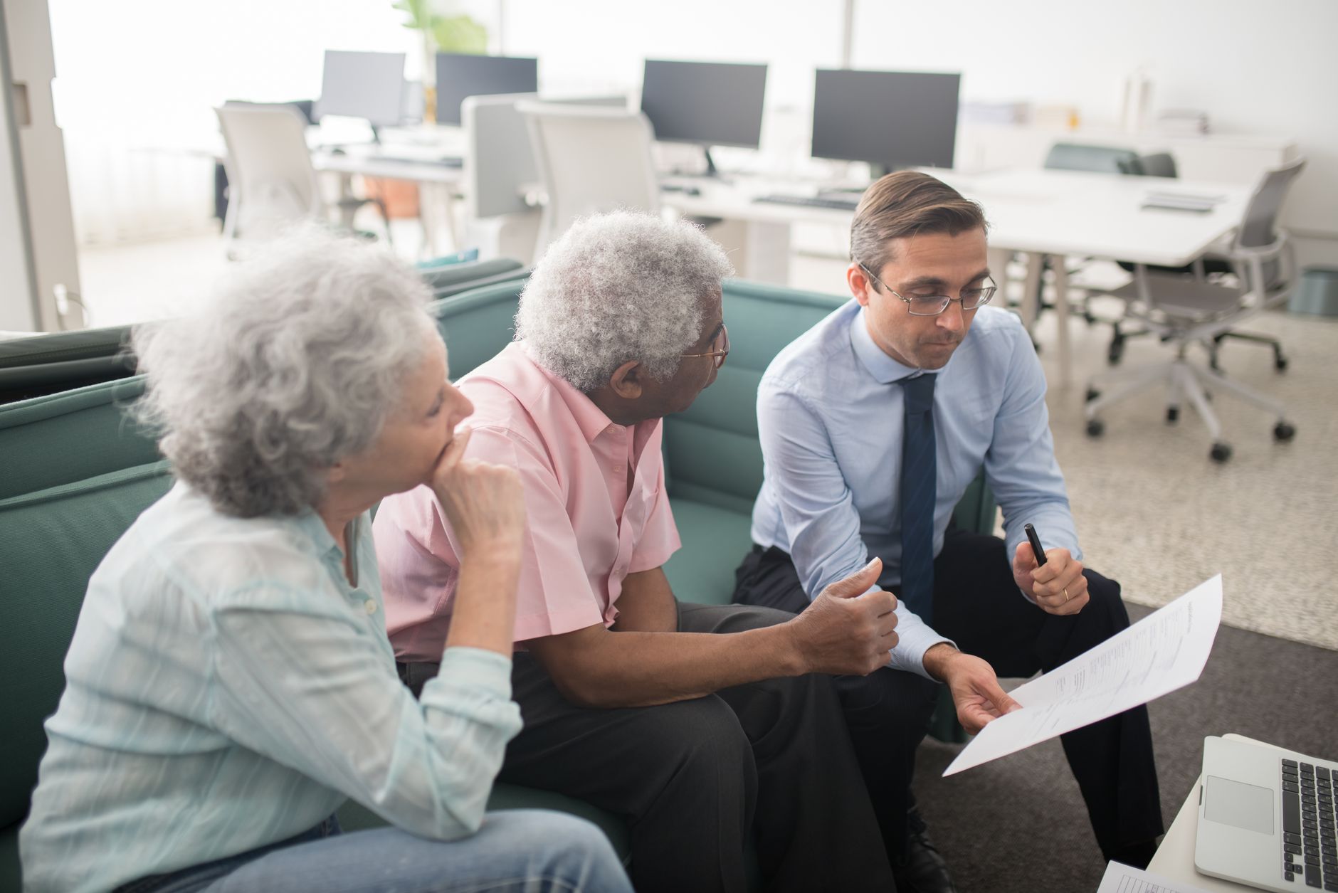 Older couple reviewing retirement financial documents at a table
