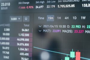 Financial trader monitoring bond market data on multiple screens