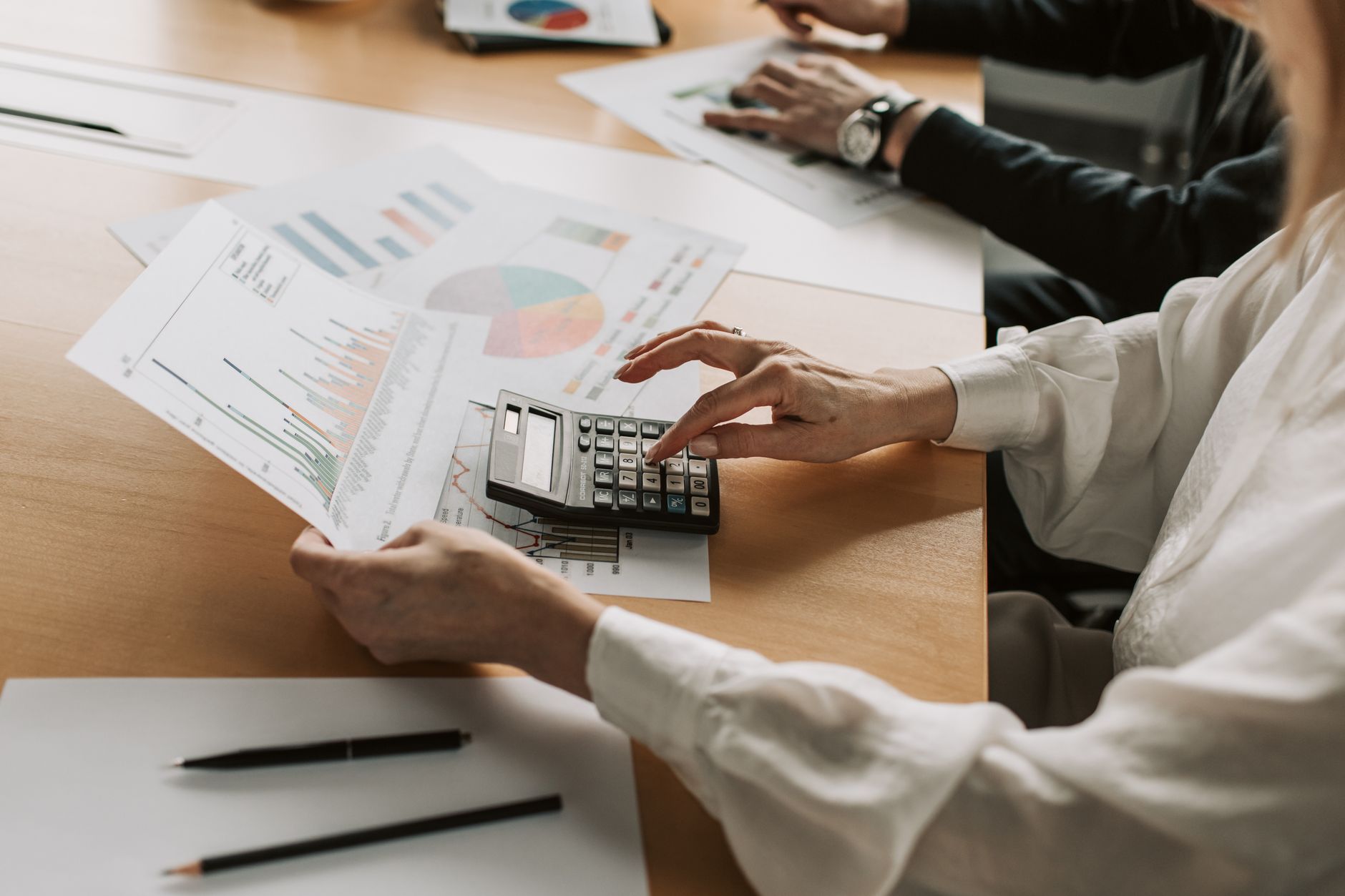 Portfolio managers reviewing investment data during a strategy meeting