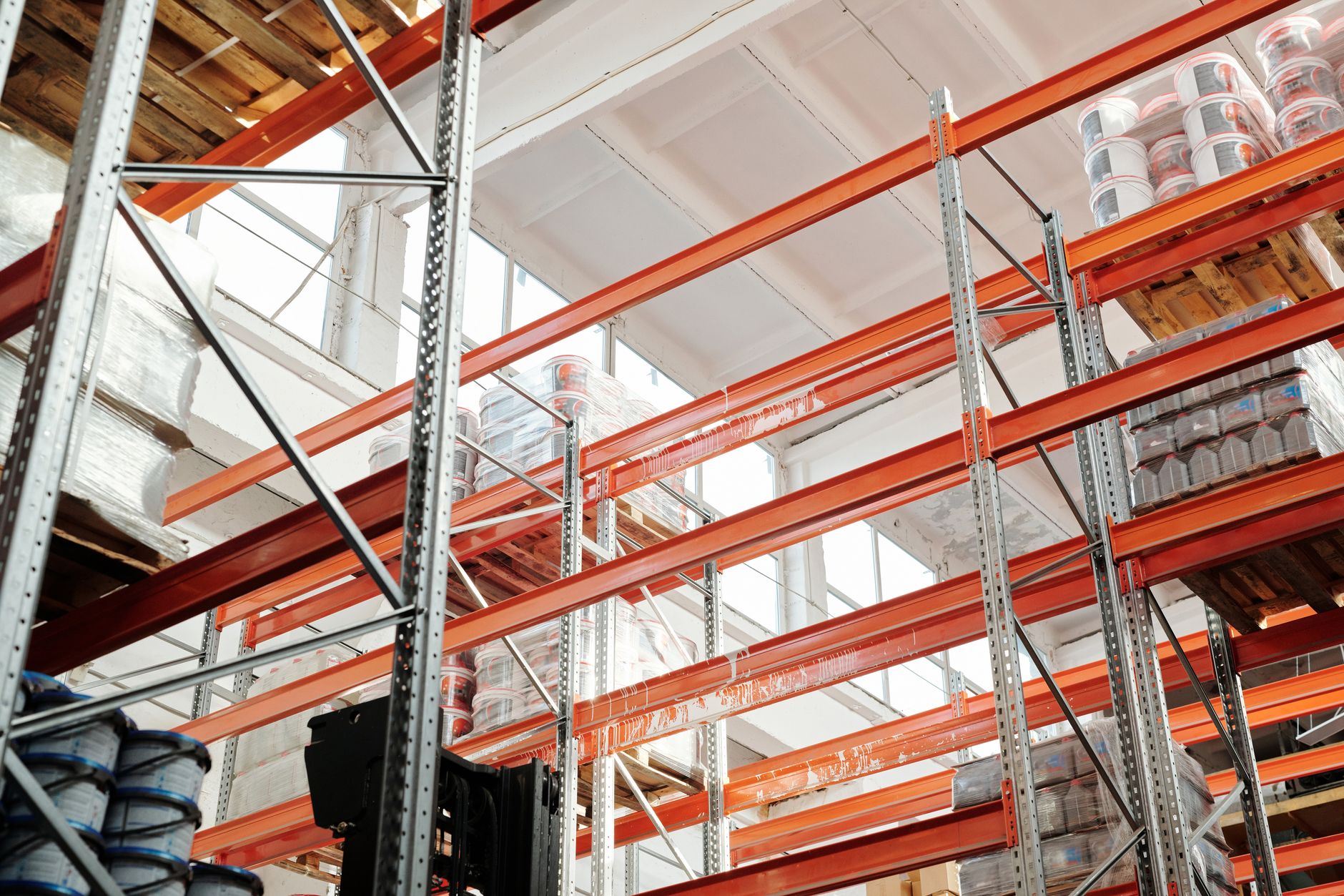 Interior of a large logistics warehouse with industrial shelving and equipment