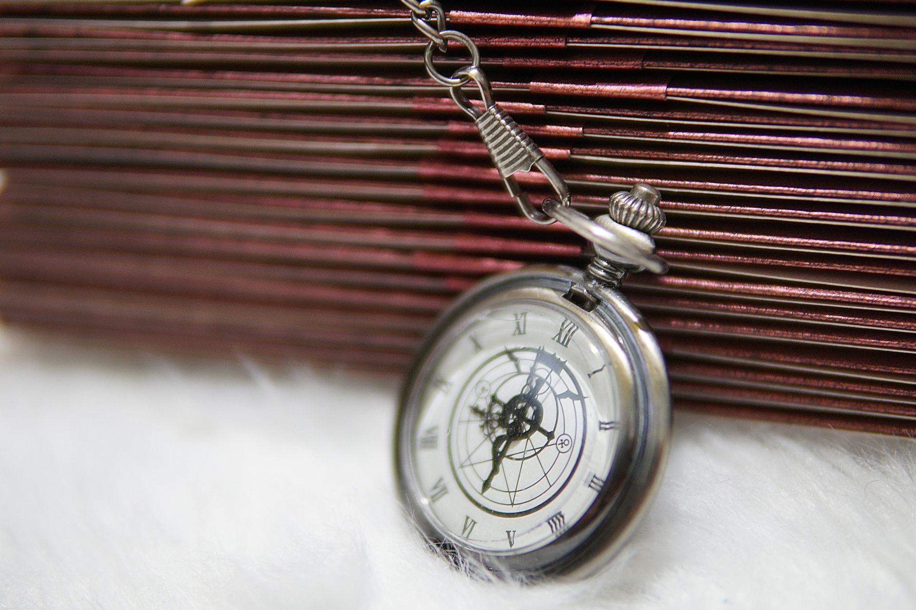 Person examining a mechanical watch closely under bright light