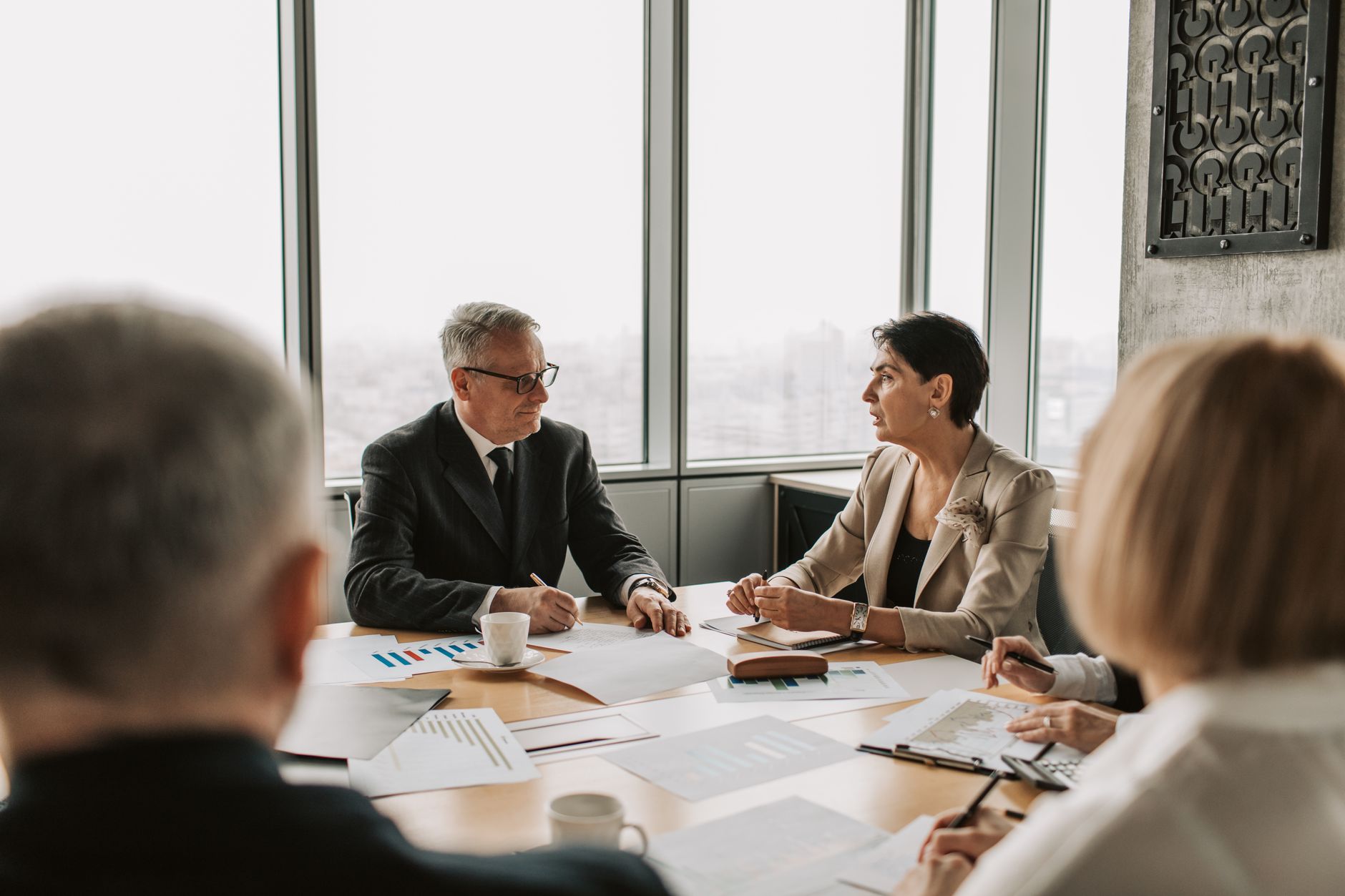 Business executives gathered around a boardroom table during a corporate strategy discussion