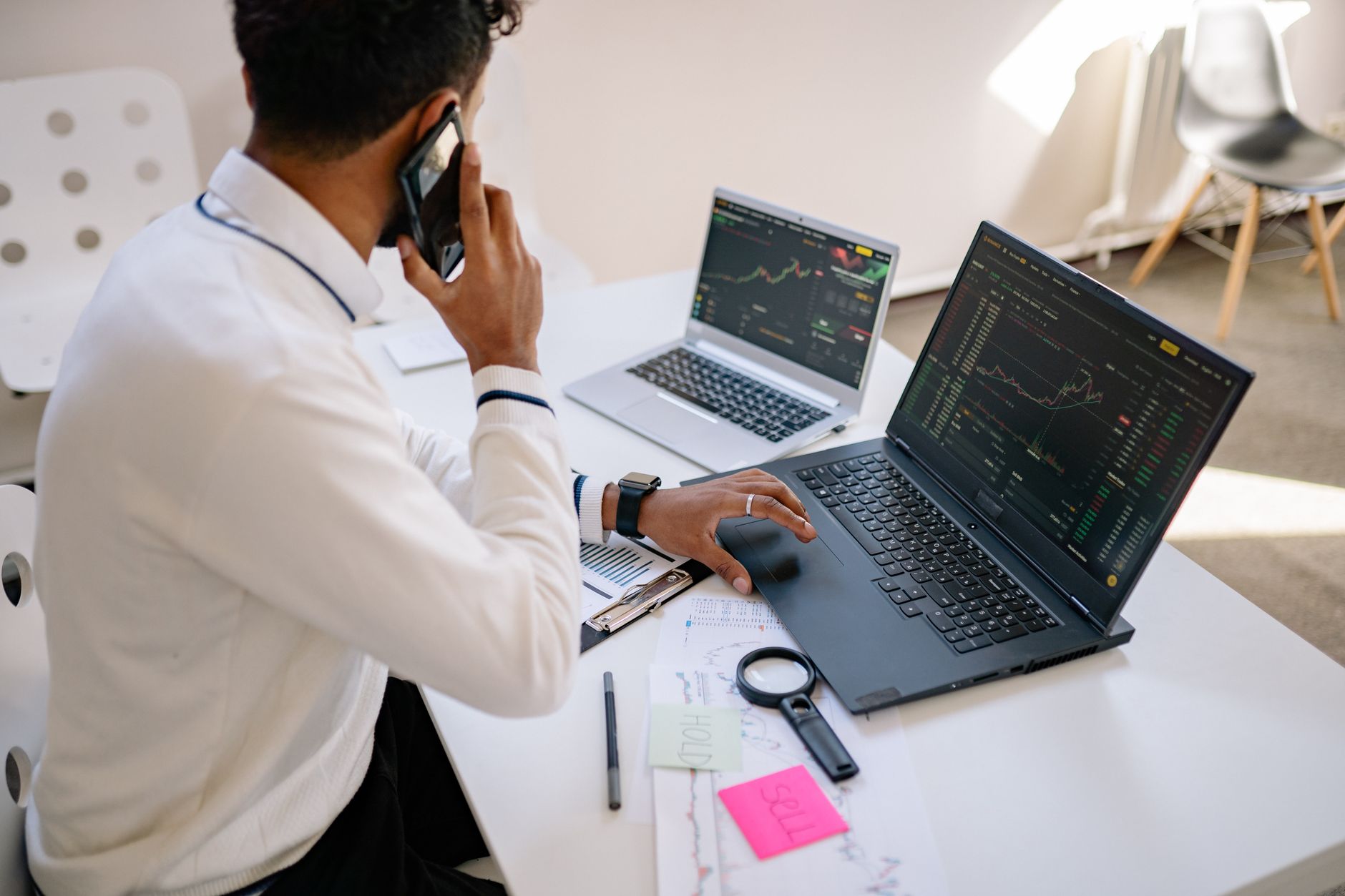 An investor reviewing fund performance data and financial reports on a computer screen