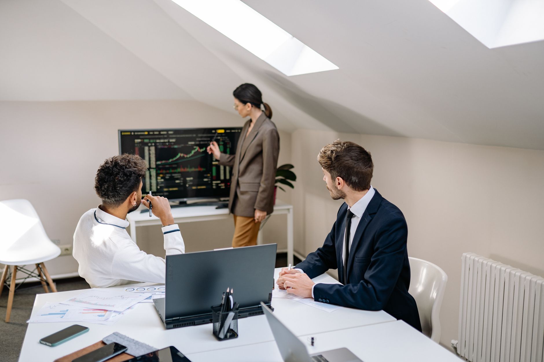 Finance professionals reviewing credit market reports in a meeting room
