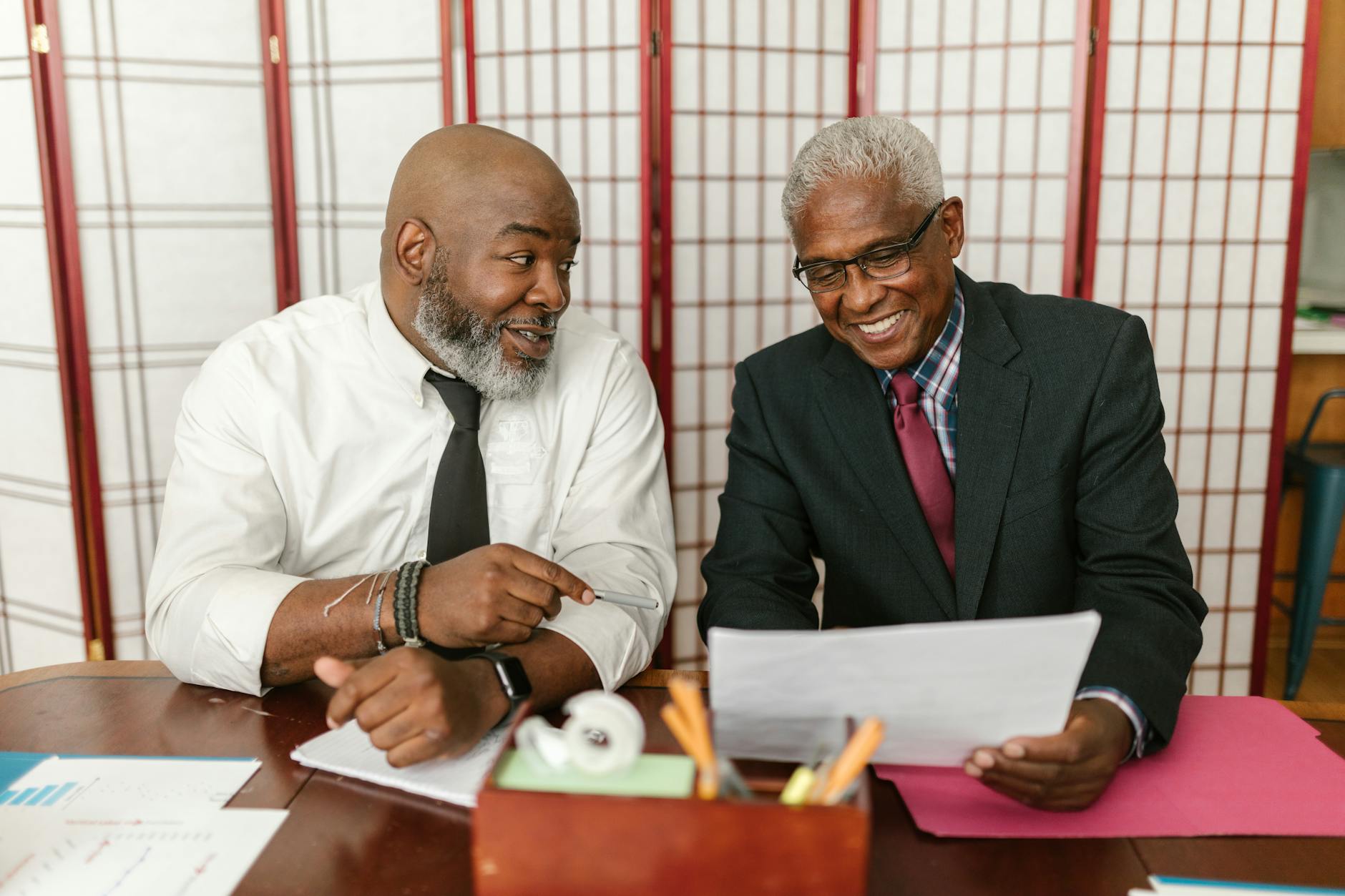 Senior man looking at financial documents with a concerned expression