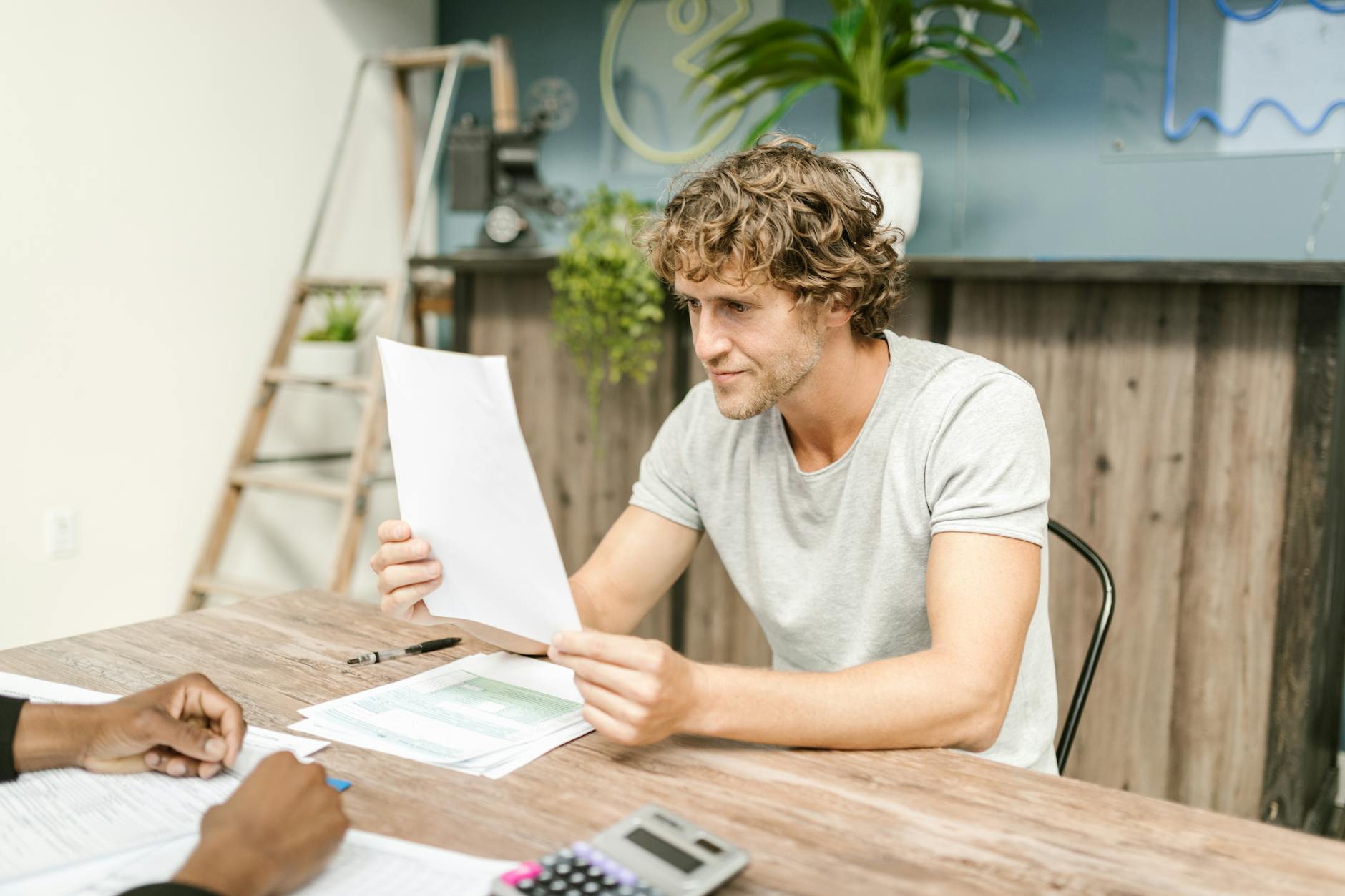 An investor reviewing financial documents and comparing investment options