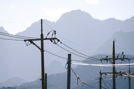 Closed-End Utility Funds Quietly Narrow Discounts as Rate Bets Cool High-voltage electric utility transmission lines against a clear sky