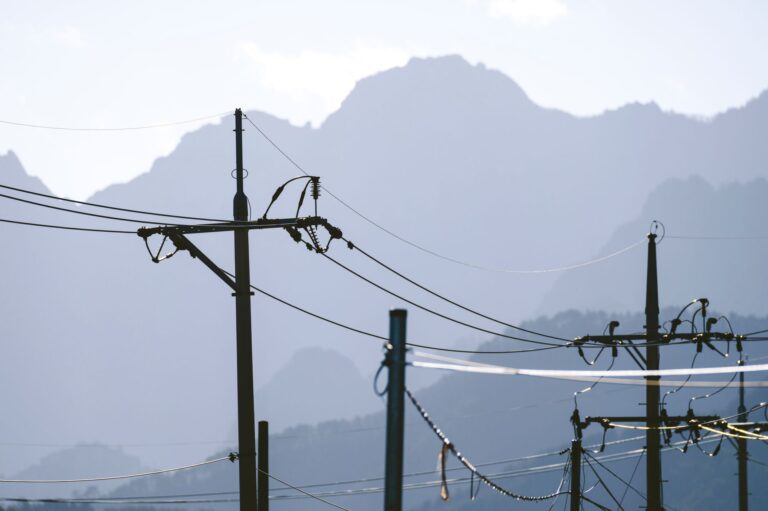 Closed-End Utility Funds Quietly Narrow Discounts as Rate Bets Cool High-voltage electric utility transmission lines against a clear sky