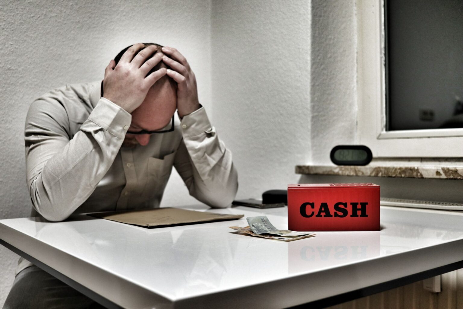 Stack of cash on a desk representing money market savings and investment decisions