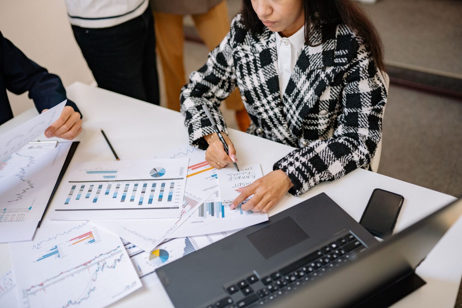Two professionals reviewing investment fund documents at a conference table