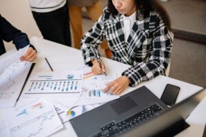 Two professionals reviewing investment fund documents at a conference table
