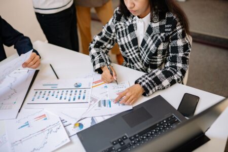 Interval Funds Quietly Expand Access to Private Credit Allocations Two professionals reviewing investment fund documents at a conference table