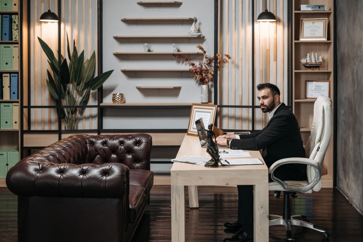 Two professionals in a formal office setting reviewing financial documents