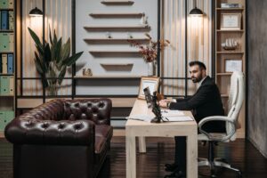Two professionals in a formal office setting reviewing financial documents