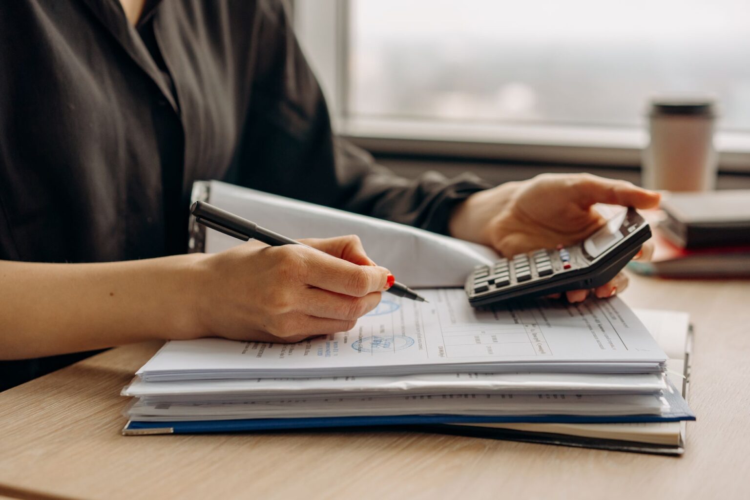 Senior Secured Loans Quietly Regain Footing as Default Fears Ease Financial documents and loan paperwork spread across a professional desk