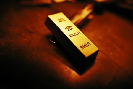 Stacked gold bars representing physical commodity holdings in real asset ETFs