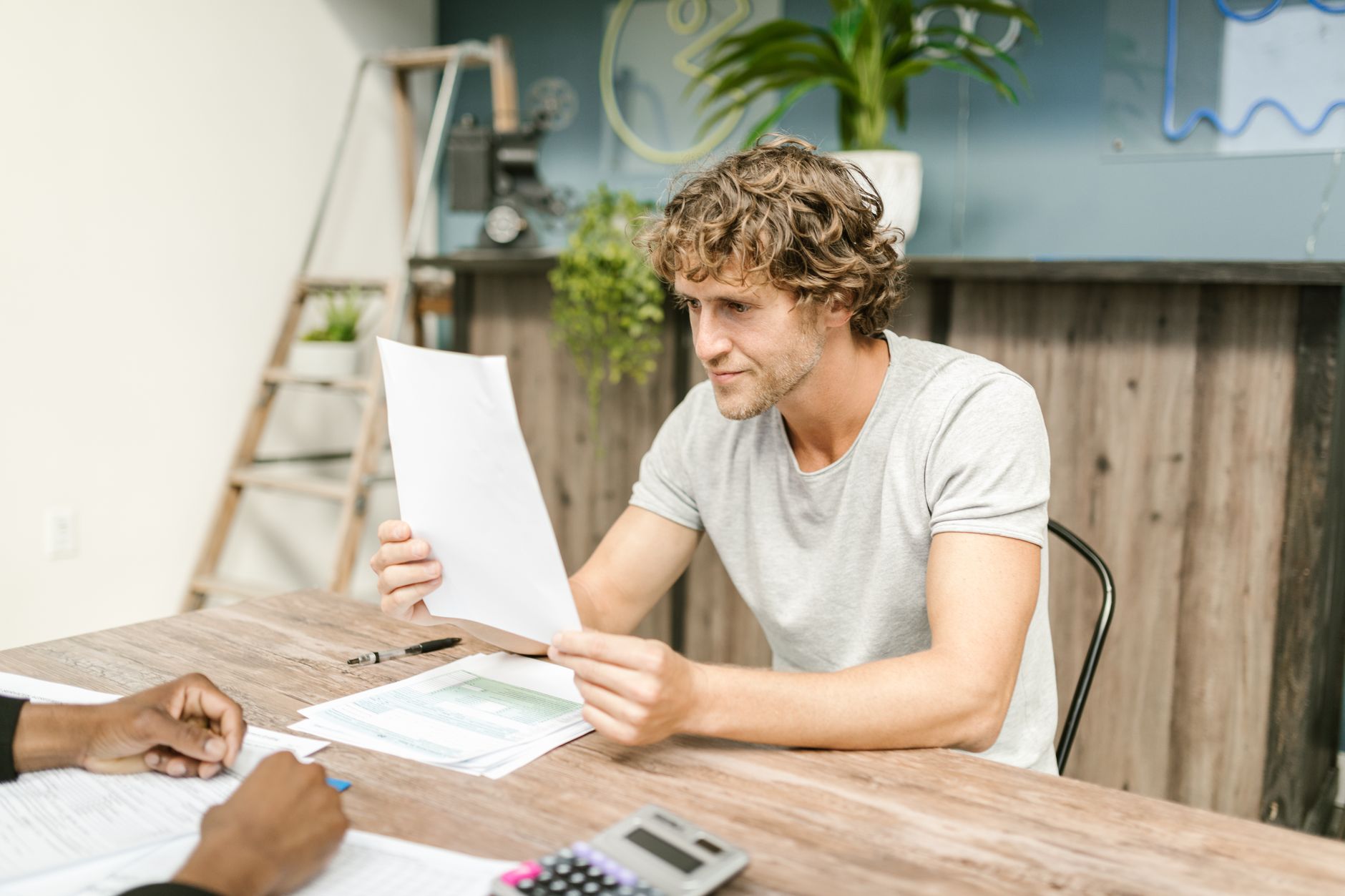 Investor sitting at desk reviewing financial fund documents