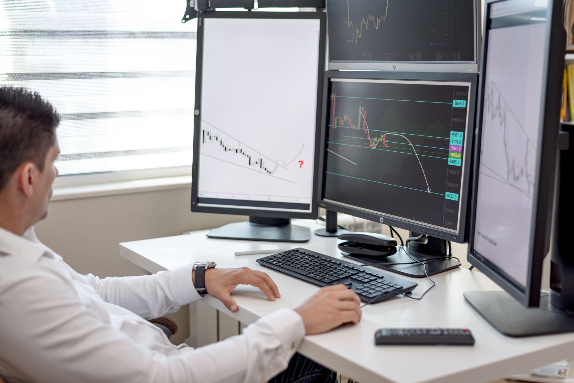 Computer screen displaying brokerage platform with investment data and charts