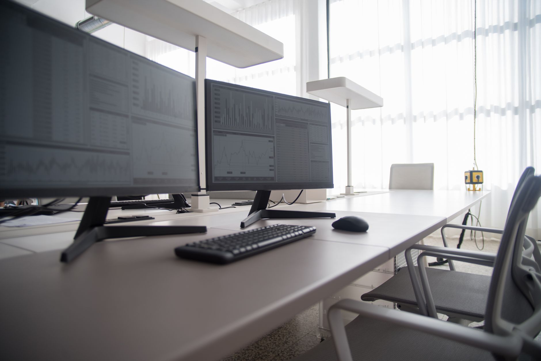 Financial analysts reviewing charts and data in a hedge fund office