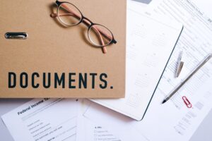 Financial documents and spreadsheets spread across a desk representing structured credit analysis