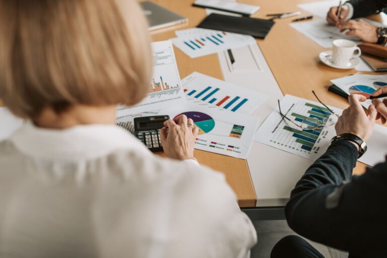 Business professionals reviewing financial documents at a conference table