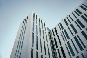 Closed-End Real Estate Funds Quietly Narrow Discounts as Cap Rates Stabilize Modern commercial real estate building exterior representing closed-end fund property holdings