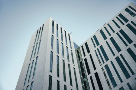 Closed-End Real Estate Funds Quietly Narrow Discounts as Cap Rates Stabilize Modern commercial real estate building exterior representing closed-end fund property holdings
