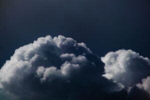 Dark storm clouds viewed from above representing catastrophe risk in reinsurance markets