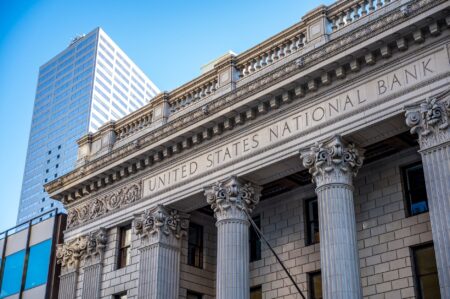 Exterior of a large commercial bank building representing institutional investment activity