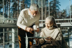A retired couple reviewing investment documents at a kitchen table