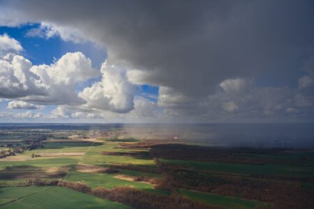 Dark storm clouds viewed from above, representing natural disaster risk in catastrophe bond investing