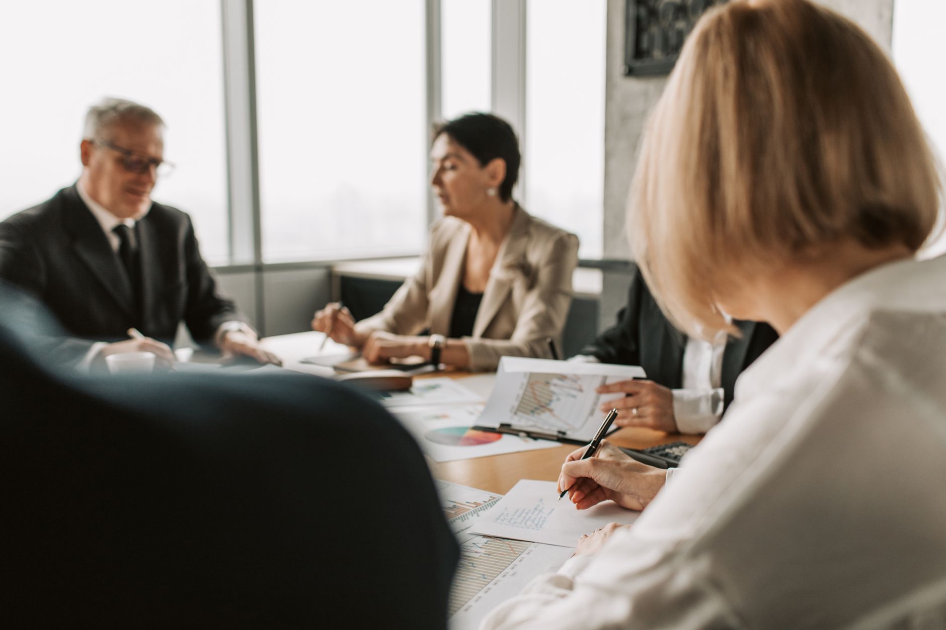 Professionals in a boardroom discussing investment strategy and fund allocation decisions