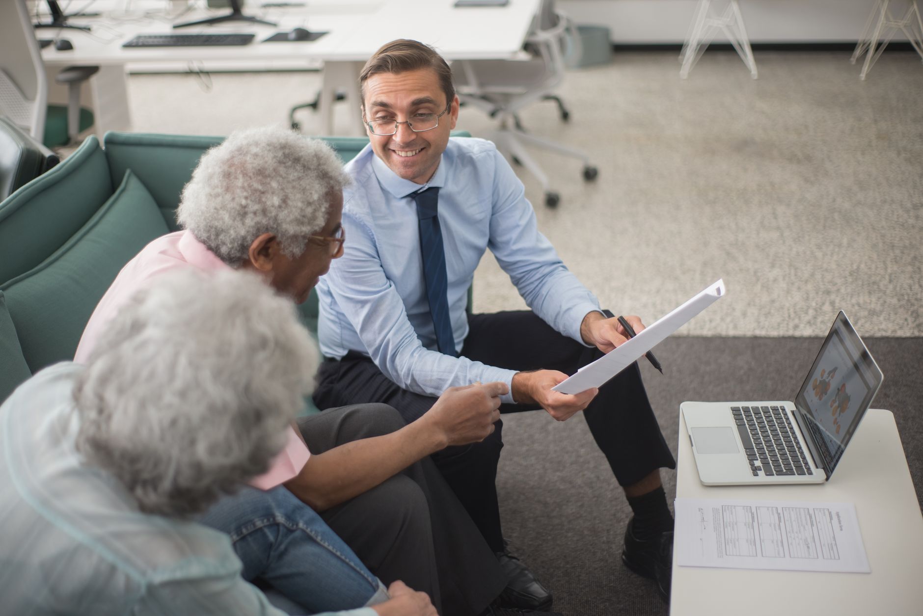 Financial advisor discussing portfolio strategy with a client at a desk