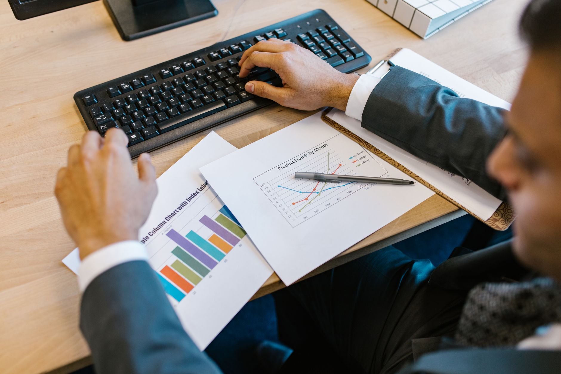 Financial analyst reviewing bond market charts and data on a desk