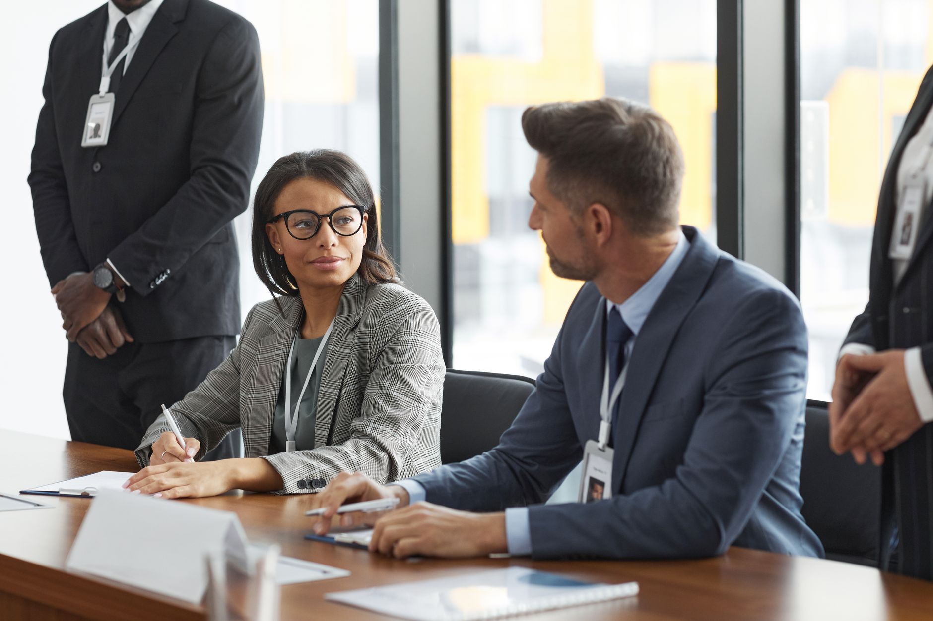 Two professionals reviewing documents at a negotiation table