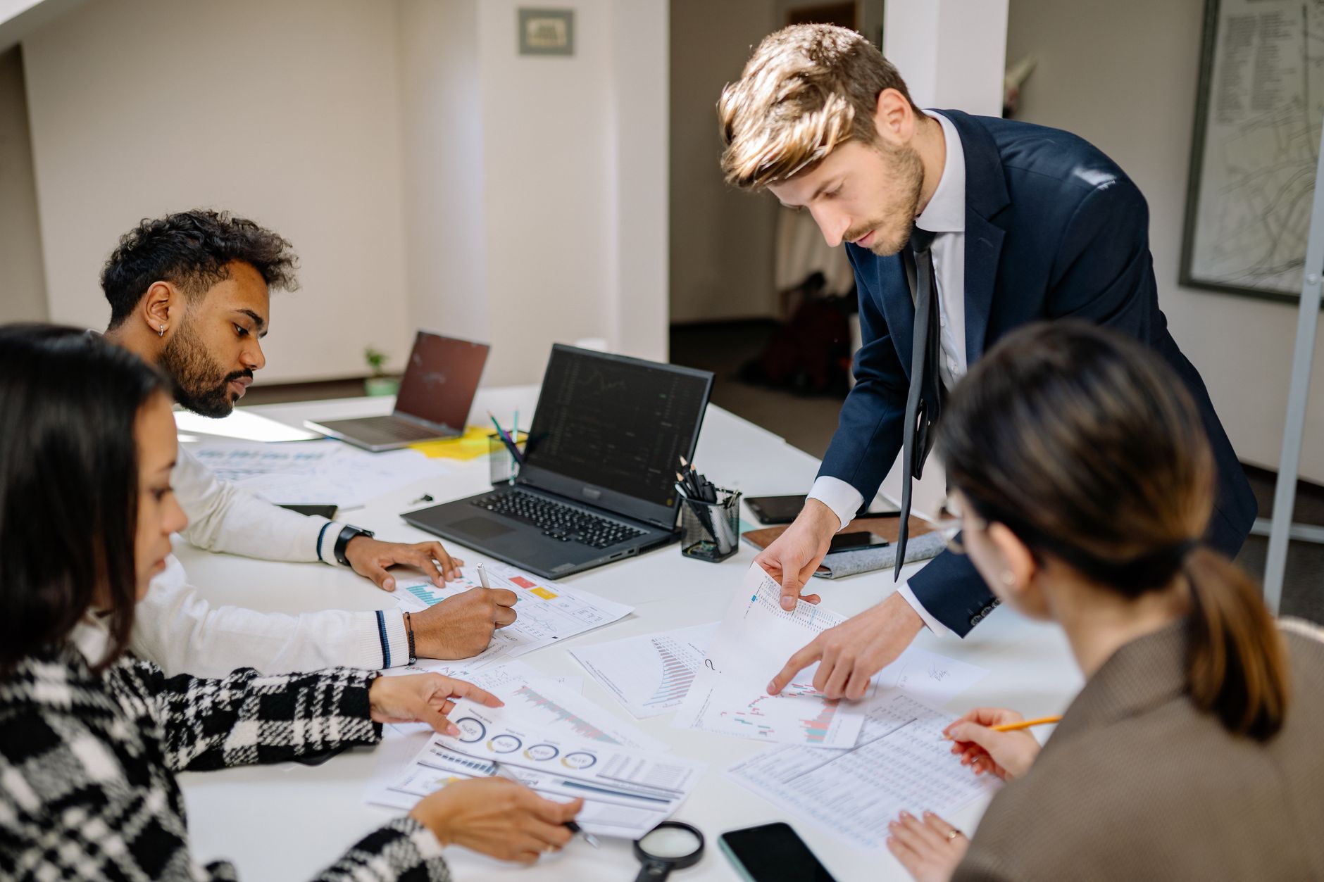 Business professionals reviewing financial documents at a conference table