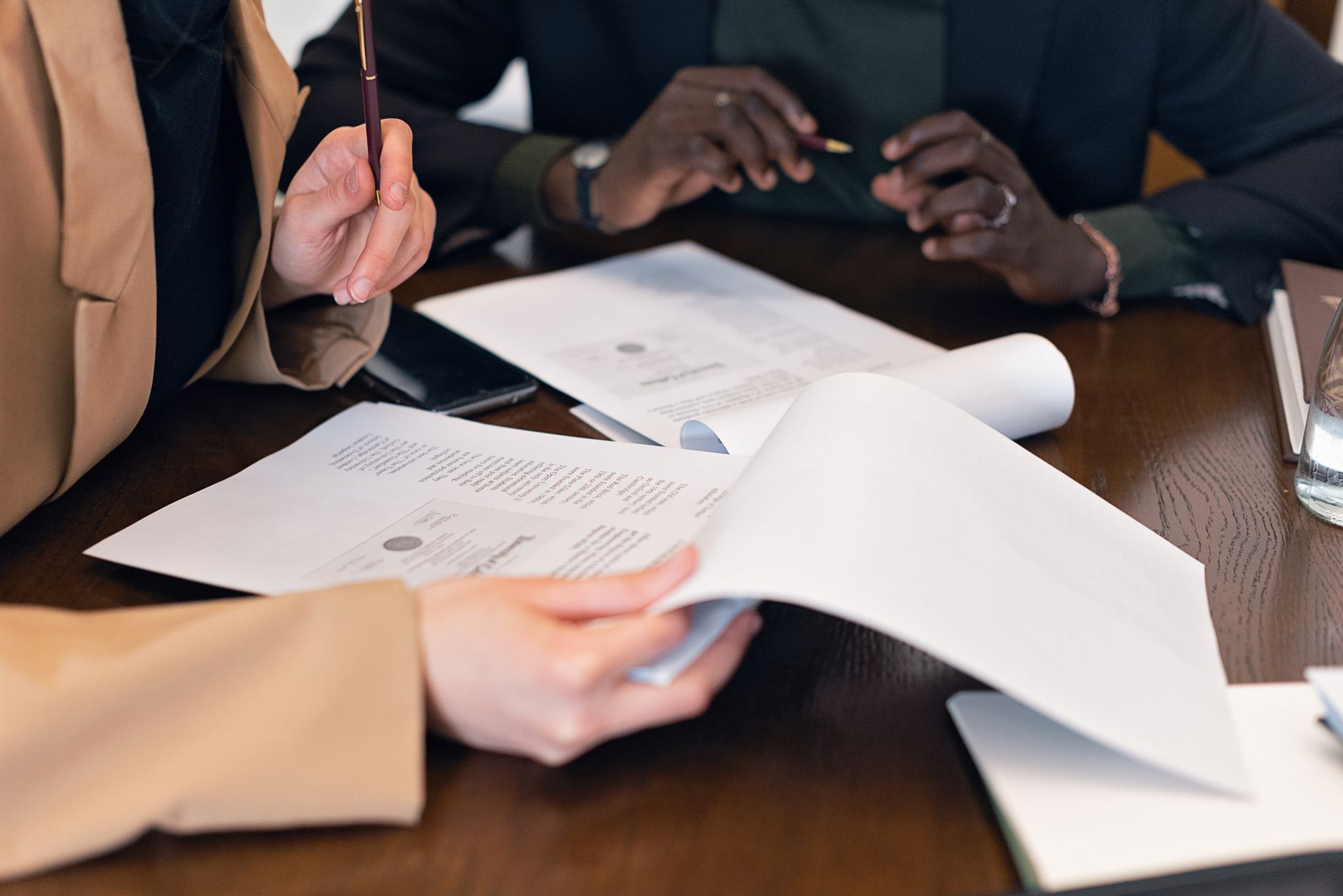 Institutional investors reviewing legal and financial documents at a conference table