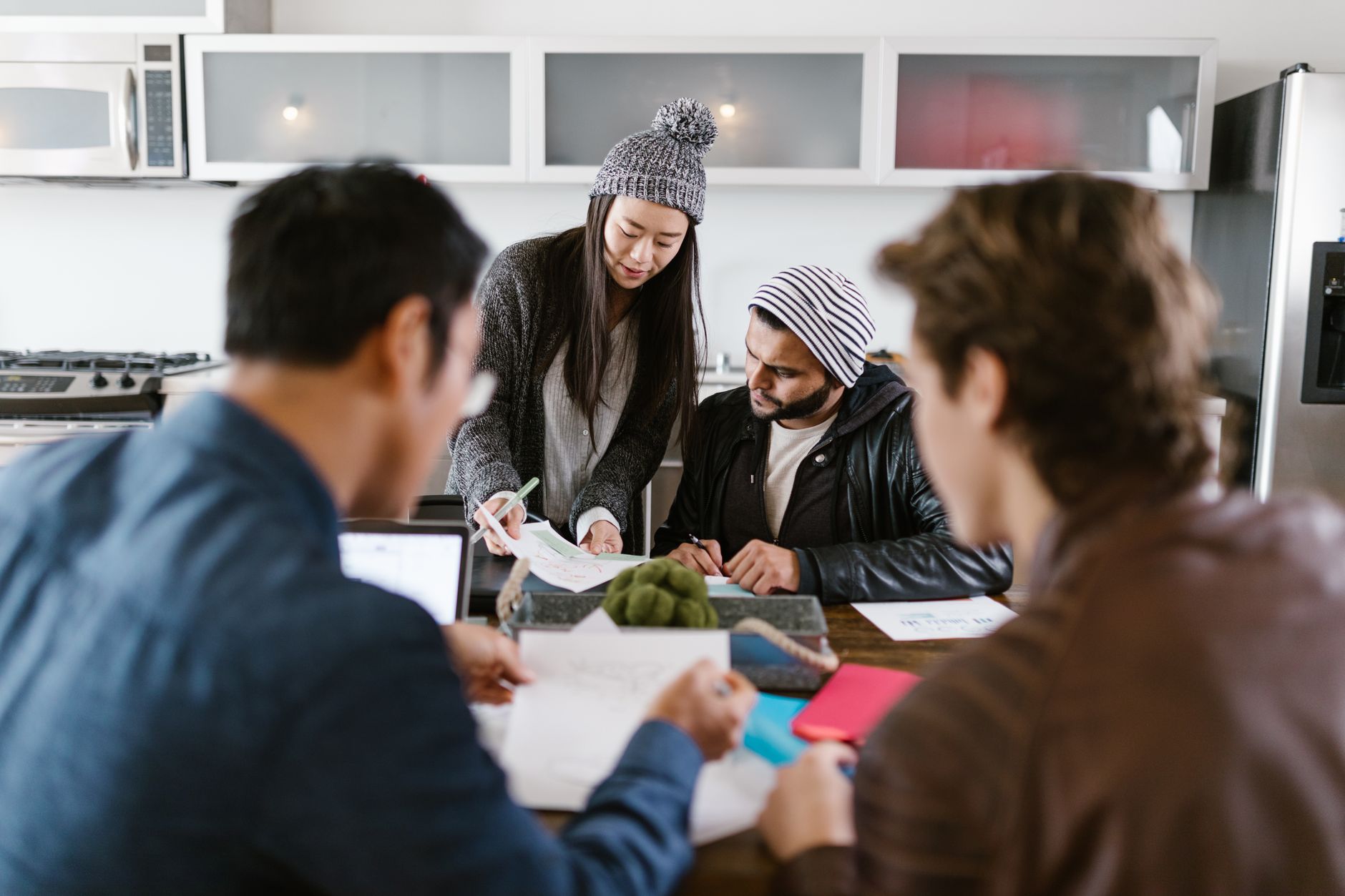 Professionals in a meeting room reviewing investment portfolio documents