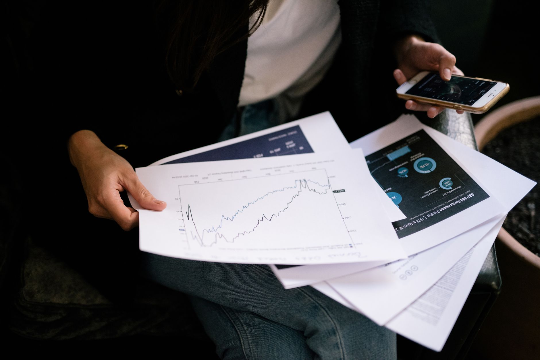 Financial documents and risk analysis reports spread across a table