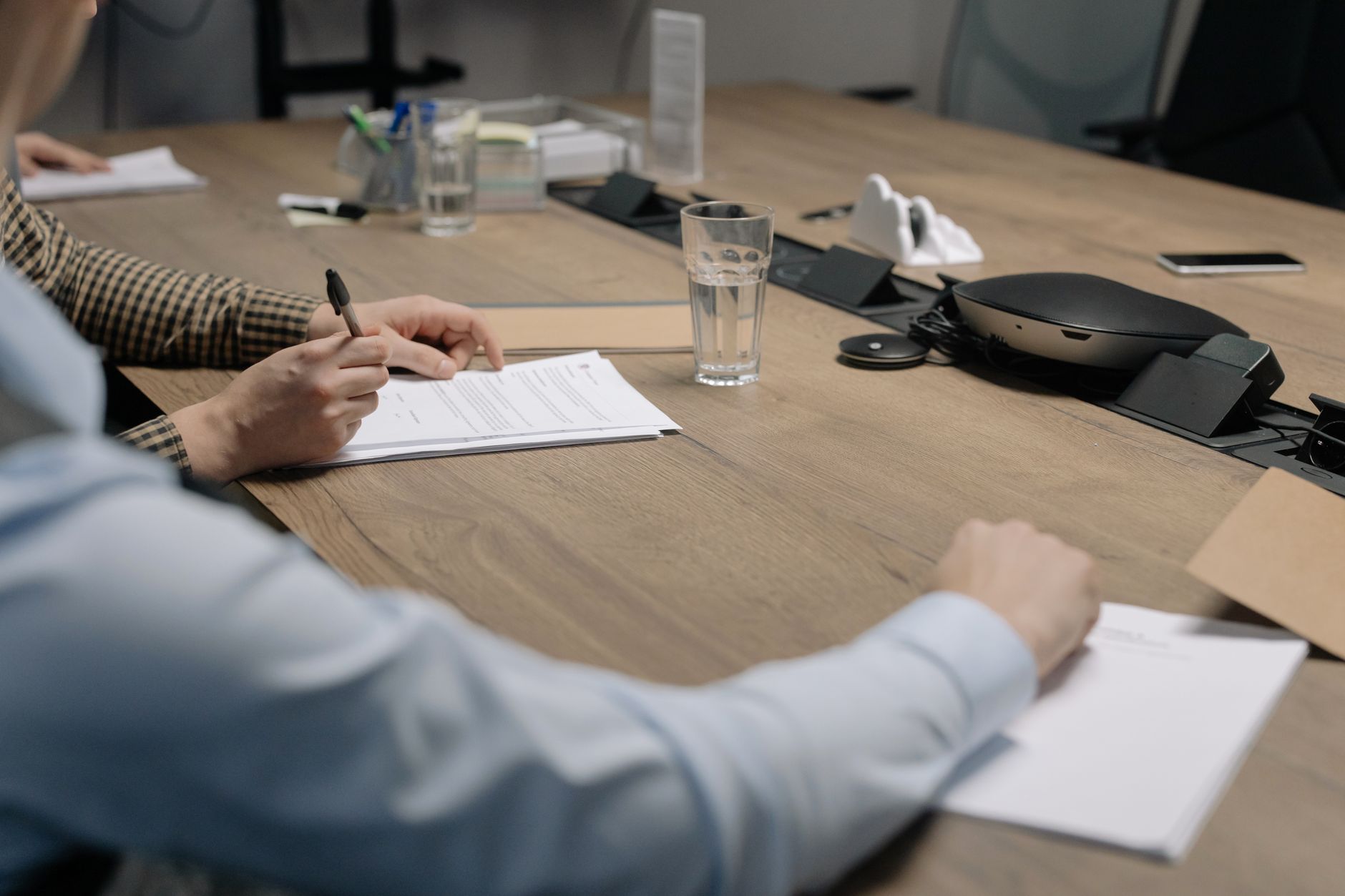 Investment professionals in a boardroom discussing portfolio strategy