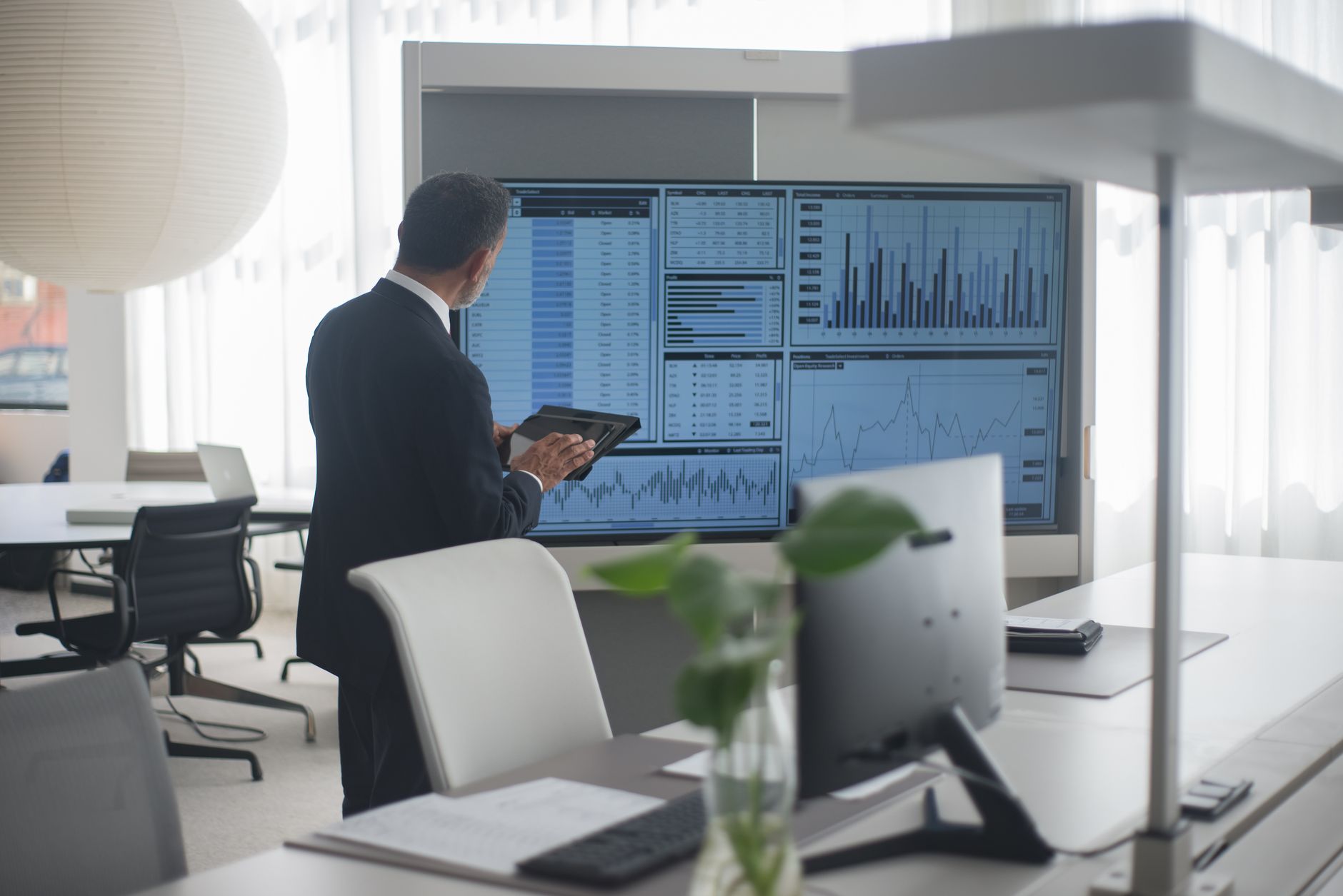 Investment professionals in a conference room reviewing fund allocation strategies