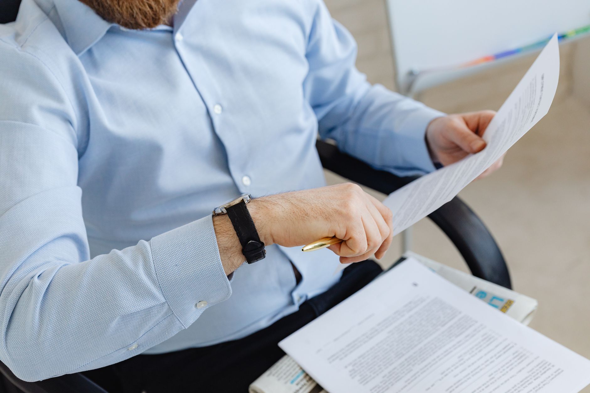 Business professional reviewing financial documents and registration statements at a desk