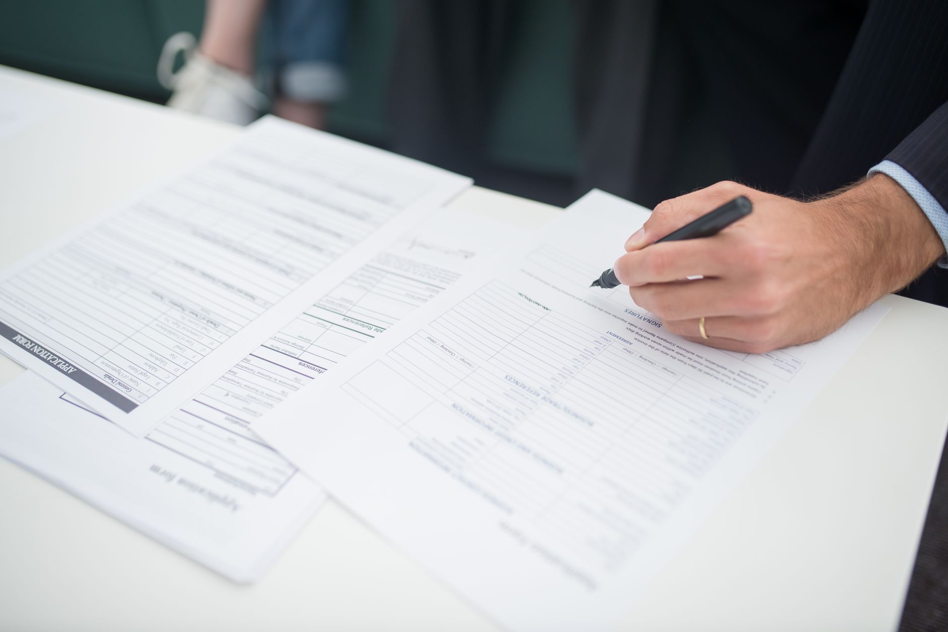 Insurance and contract documents spread across an office desk representing reinsurance agreements
