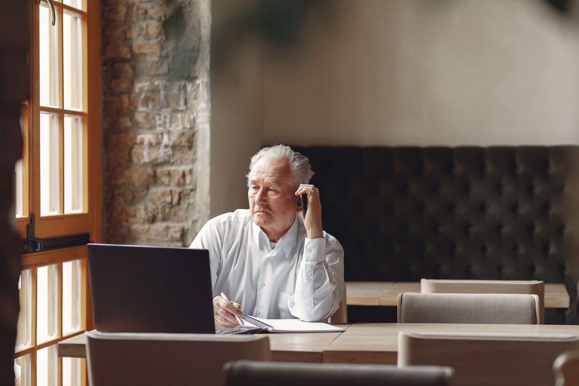 A senior investor reviewing portfolio data on a laptop at home
