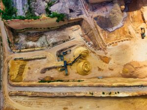 Open pit copper mine showing large-scale raw material extraction operations