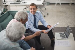 Interval Funds Quietly Absorb Illiquidity Premium Demand from RIAs Financial advisor reviewing portfolio documents with a client at a desk