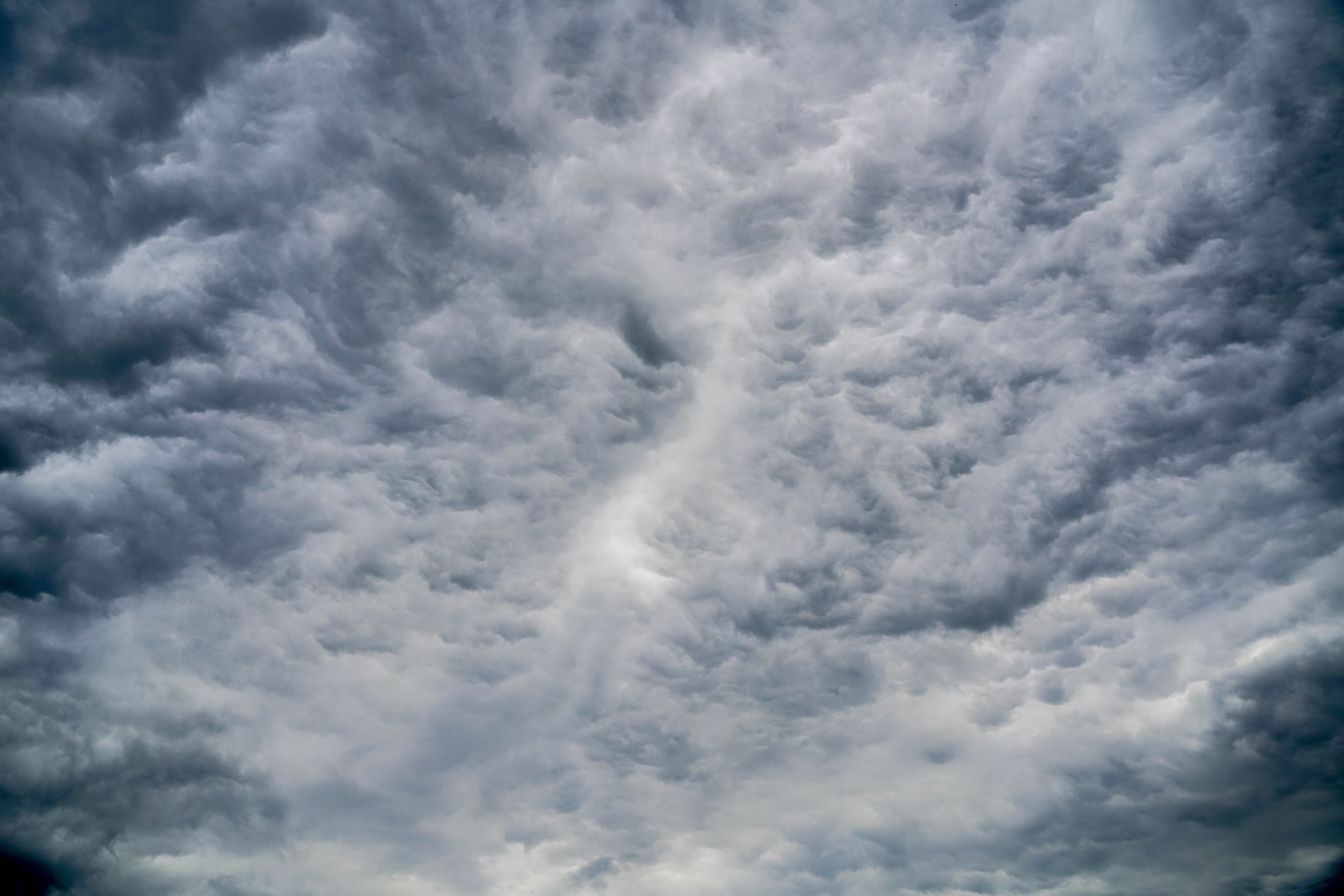Aerial view of dark storm clouds forming over open landscape, representing catastrophe weather risk