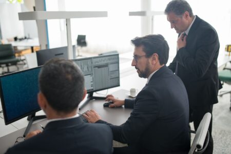 Convertible Bond Arbitrage Quietly Returns as Rate Spreads Widen Traders working at a financial desk analyzing bond market data on multiple screens