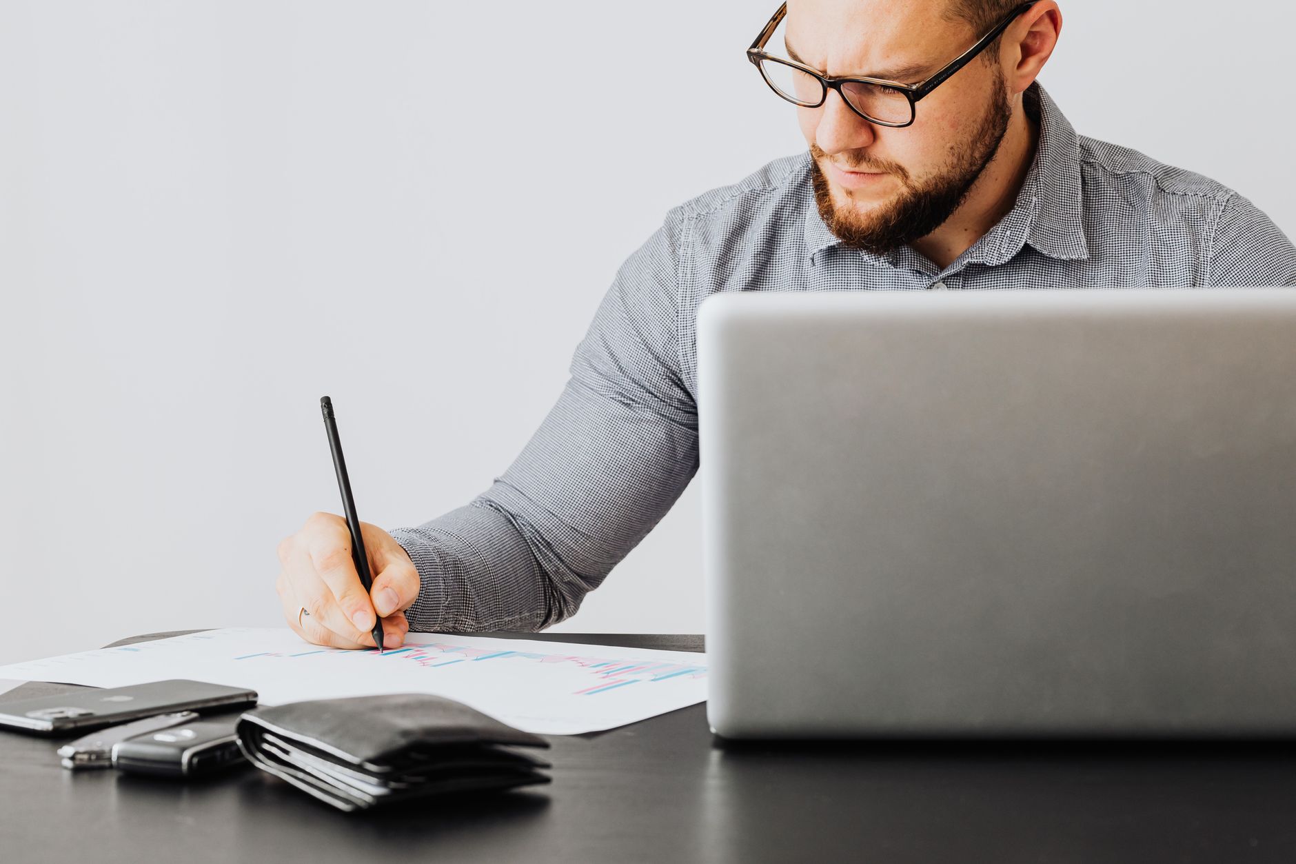Financial documents and charts spread across a desk representing portfolio cash management