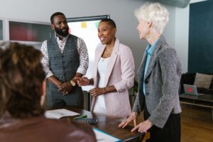 Secondhand Private Equity Stakes Quietly Find Buyers on Secondary Markets Business professionals reviewing investment documents at a conference table